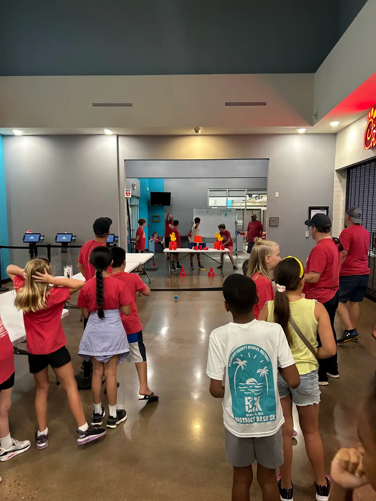 Three Bridge Kids VBS volunteers smiling together in their Step Right Up t-shirts