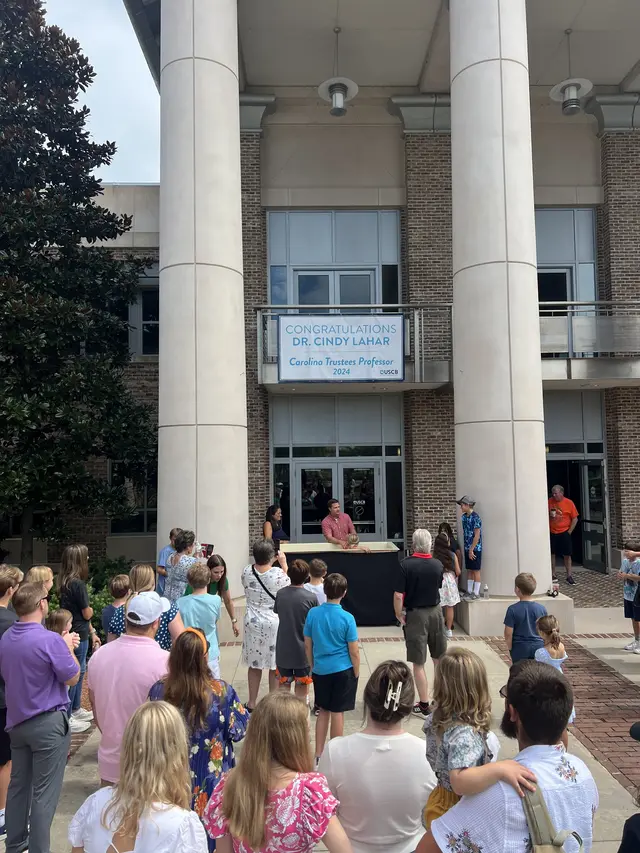 The church family gathered outside the USCB campus center to celebrate a baptism Sunday