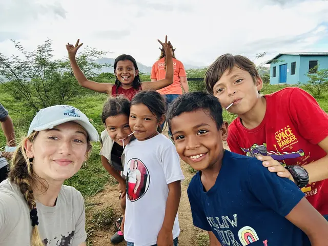 A Bridge Church team member taking a photo with children from the community