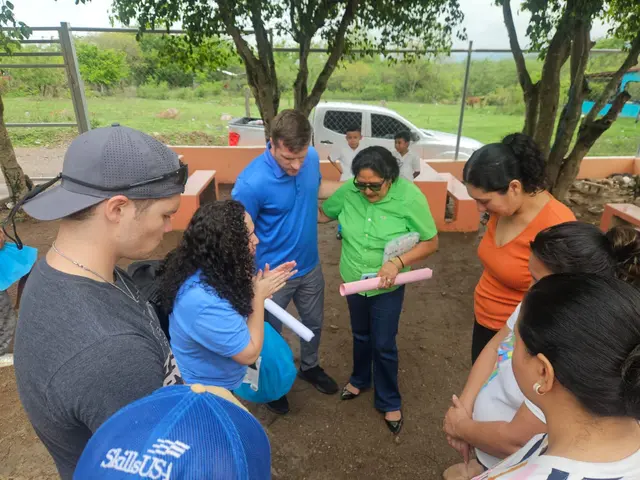 Team members handing out supplies and talking with local families